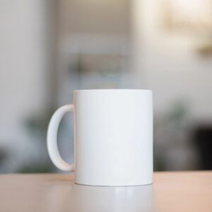 Branded mug mockup: white mug on neutral background for Grace The Magazine shop.